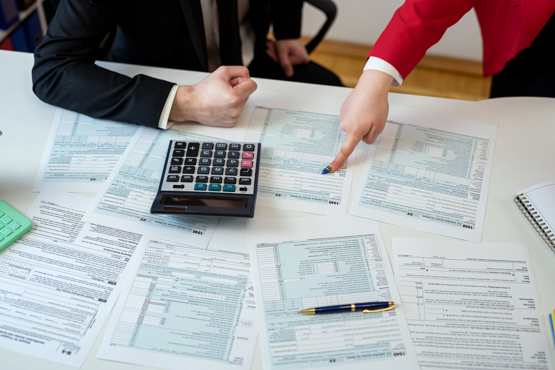 Two people are filling out a tax form, talking and discussing how to do the right thing